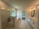 Elegant bathroom featuring glass shower, soaking tub, double vanity, and ample natural light at 6945 Melody Ridge Rd, Buford, GA 30518