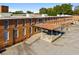 Exterior view of a rustic brick building with an awning, showcasing industrial charm at 6945 Melody Ridge Rd, Buford, GA 30518