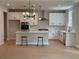 Modern kitchen with stainless steel appliances, white cabinetry, and a large center island with seating at 6945 Melody Ridge Rd, Buford, GA 30518
