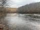 Scenic lake view with a dam in the background, offering a tranquil waterside setting at 6945 Melody Ridge Rd, Buford, GA 30518