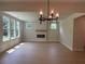 Bright living room with wood floors, large windows, and a fireplace for a comfortable living space at 6945 Melody Ridge Rd, Buford, GA 30518
