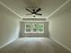 Spacious bedroom with tray ceiling, neutral carpet, and large windows that let in plenty of natural light at 6945 Melody Ridge Rd, Buford, GA 30518