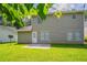 Well-maintained backyard with green grass and rear access door to the house at 711 Ashley Ln, Stone Mountain, GA 30087