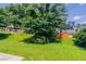 Overgrown back yard with mature shade trees on a sunny day at 711 Ashley Ln, Stone Mountain, GA 30087