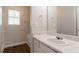 This bathroom features a single sink vanity, toilet, tub and window at 711 Ashley Ln, Stone Mountain, GA 30087