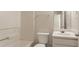 This bathroom includes a white vanity, toilet and tub at 711 Ashley Ln, Stone Mountain, GA 30087