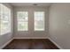 Bright bedroom offering two windows, laminate floors and neutral walls at 711 Ashley Ln, Stone Mountain, GA 30087