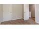 This bedroom offers carpeted floors and white doors at 711 Ashley Ln, Stone Mountain, GA 30087