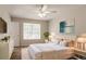 Bright, airy bedroom featuring neutral tones, large window, modern decor, and soft carpet at 711 Ashley Ln, Stone Mountain, GA 30087