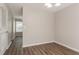 Open dining area with hardwood floors and stylish lighting, enhancing the space at 711 Ashley Ln, Stone Mountain, GA 30087