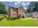 Beautiful two-story brick home with a well-manicured lawn and lush landscaping for great curb appeal at 711 Ashley Ln, Stone Mountain, GA 30087