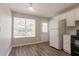 Clean kitchen features white cabinets, dark appliances, and stylish vinyl flooring at 711 Ashley Ln, Stone Mountain, GA 30087