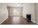 Spacious living area with hardwood floors, a fireplace, and bright natural light at 711 Ashley Ln, Stone Mountain, GA 30087
