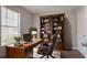 Cozy office space features a large bookcase, desk, and comfortable leather chair at 711 Ashley Ln, Stone Mountain, GA 30087