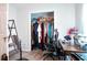 This closet has hanging clothes and a shelf with black fan and desk at 7270 Williamsburg Dr, Riverdale, GA 30274