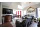 Open living room with cathedral ceilings, fireplace and dark furniture that leads into the kitchen area at 7270 Williamsburg Dr, Riverdale, GA 30274