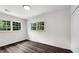Bright bedroom featuring hardwood floors and natural light from two large windows at 2550 Laurel Ridge Dr, Decatur, GA 30033