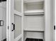 Walk-in closet with black rod, white shelving, glass sliding door, and black hexagon tile floor at 2550 Laurel Ridge Dr, Decatur, GA 30033