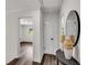 Hallway with wood flooring and a view into another room with natural light at 2550 Laurel Ridge Dr, Decatur, GA 30033
