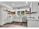 Well-lit kitchen featuring stainless steel appliances, white cabinetry, wood shelves and sleek wood floors at 2550 Laurel Ridge Dr, Decatur, GA 30033