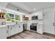 Bright kitchen featuring white cabinets, subway tile backsplash, stainless steel appliances, and open shelving at 2550 Laurel Ridge Dr, Decatur, GA 30033