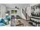Bright living room featuring neutral walls and wood floors, modern furniture, and a staircase with a wood railing at 2550 Laurel Ridge Dr, Decatur, GA 30033