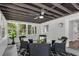 Relaxing sunroom featuring large windows, comfortable seating, and a ceiling fan at 2550 Laurel Ridge Dr, Decatur, GA 30033