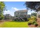 Expansive backyard featuring lush green grass, a wooden fence, a deck and stairs to the ground level at 428 Gold Xing, Canton, GA 30114