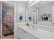 Bright bathroom featuring a white vanity, baseball-themed shower curtain and decorative wall art at 428 Gold Xing, Canton, GA 30114