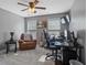 Comfortable bedroom features neutral walls, a ceiling fan, a banjo, and a well-appointed workspace at 428 Gold Xing, Canton, GA 30114