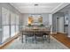 Light-filled dining room with a wooden table, area rug, and large windows at 428 Gold Xing, Canton, GA 30114