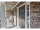 Inviting front porch with a stone exterior, comfortable seating and stylish lighting fixtures at 428 Gold Xing, Canton, GA 30114
