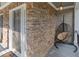 Charming stone porch with a hanging chair and a stylish front door with sidelights at 428 Gold Xing, Canton, GA 30114