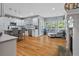 Bright kitchen with a breakfast bar, white cabinets, stainless appliances, and a cozy seating area at 428 Gold Xing, Canton, GA 30114