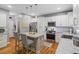 Bright kitchen boasts white cabinets, granite countertops, stainless steel appliances, and a convenient breakfast bar at 428 Gold Xing, Canton, GA 30114