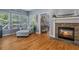 Inviting living room featuring hardwood floors, a stone fireplace, and a cozy seating area near large windows at 428 Gold Xing, Canton, GA 30114