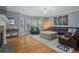Cozy living room with hardwood floors, a stone fireplace, and comfortable seating arrangements at 428 Gold Xing, Canton, GA 30114