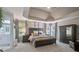 Luxurious main bedroom with a trey ceiling, large windows, and a view into the bathroom at 428 Gold Xing, Canton, GA 30114