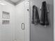 Modern walk-in shower featuring white subway tile, a glass door, and built-in shelving for toiletries at 428 Gold Xing, Canton, GA 30114
