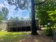 Backyard with a large deck, partially shaded by mature trees at 4434 Janice Dr, Snellville, GA 30039