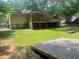 Spacious backyard with a raised deck and mature trees is ideal for outdoor activities at 4434 Janice Dr, Snellville, GA 30039