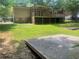 Home's lush backyard with a raised wooden deck, perfect for outdoor gatherings at 4434 Janice Dr, Snellville, GA 30039