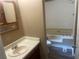 Cozy bathroom with tub and shower, cabinet with mirror, and wood grain floors at 4434 Janice Dr, Snellville, GA 30039