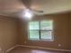 This bedroom features a ceiling fan and a window offering natural light at 4434 Janice Dr, Snellville, GA 30039