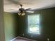Bedroom features a ceiling fan and natural light from a window at 4434 Janice Dr, Snellville, GA 30039