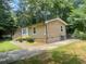 Charming single-story home with tan siding, landscaped yard, and paved driveway at 4434 Janice Dr, Snellville, GA 30039
