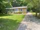 Cozy home boasting a neatly manicured lawn and a long paved driveway at 4434 Janice Dr, Snellville, GA 30039