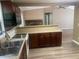 Open kitchen features stainless steel sink, stone countertops, and dark cabinets at 4434 Janice Dr, Snellville, GA 30039