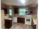 Well-lit kitchen with white appliances, wooden cabinets, and a modern design at 4434 Janice Dr, Snellville, GA 30039