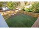 An expansive backyard with a fire pit, wooden fence, and lush greenery viewed from the house deck at 963 Turner Se Dr, Smyrna, GA 30080
